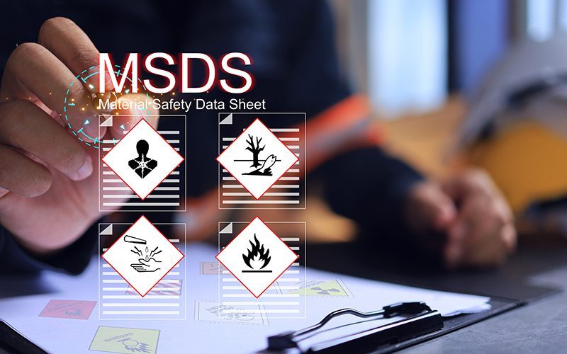 Safety officer writing on MSDS or material safety data sheet to indicate chemical information, basic antidotes or hazards to the body in area of use for emergency case safety work concept.